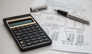 Services Close-up of financial documents with calculator and pen, ideal for business management themes.